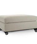 Heavy Duty 2 Inch Swivel Furniture Caster Wheels With Plastic Plate gliding smoothly under a beige ottoman for easy movement.