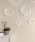 Claremont Ceiling Medallion Nine Inch Outer Diameter, Inner Opening Four and a Half Inches, One Half Inch Projection displayed on wall