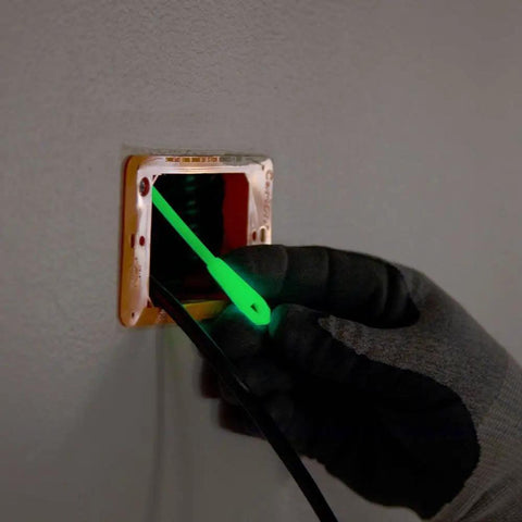 Glow In The Dark 20 Foot Fiberglass Fish Tape With Nylon Tip And Stainless Steel Connector Removable Case For Versatile Wire Feeding And Quick Pass Through Made In USA tool being fed through an electrical outlet.