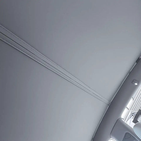 Interior view of Tesla Model Y Roof Sunshade Full Blackout with Graphene Enhanced UV Coating installed, showing seamless fit and gray fabric.