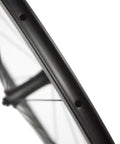 Close-up of Beast 700C Road Carbon Wheelset With 50mm Deep Section, matte 3K finish, Toray T700 carbon fiber and basalt braking surface.