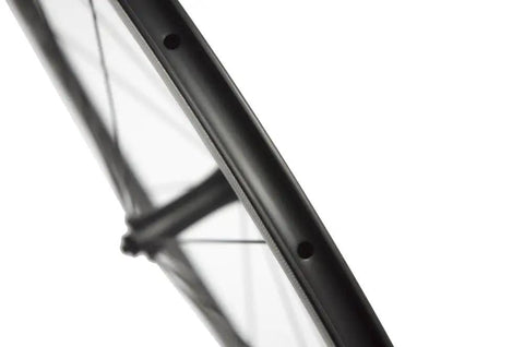 Close-up of Beast 700C Road Carbon Wheelset With 50mm Deep Section, matte 3K finish, Toray T700 carbon fiber and basalt braking surface.