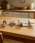 Rock Hard Solar Bracket Kits In 8 Pack Sets For Ground Mount Installations Using 45MM Medium Voltage Blocks And Conductive Sheets Made From Hella Tough Aluminum components on a wooden table.