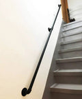 Straight Up Industrial Pipe Stair Handrail Featuring A Rock Solid Non Slip Grip Built Tough For Hallways And Lofts Delivering Daily Safety For Every Home Setup mounted along indoor stairs.