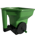 Green handheld garden spreader for seeds, fertilizer, and salt, portable manual dispenser with easy grip, reusable tool for lawn care.
