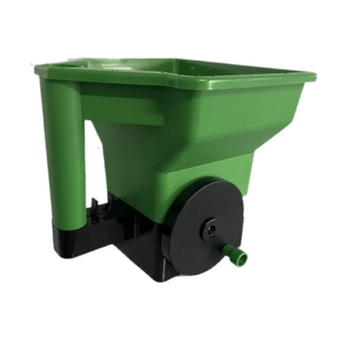Green handheld garden spreader for seeds, fertilizer, and salt, portable manual dispenser with easy grip, reusable tool for lawn care.