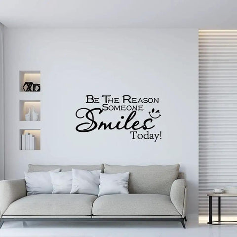 Room with Motivational Wall Sticker Quote Be The Reason Someone Smiles Today Removable Vinyl Wall Art Decal for Classroom Office Bedroom Home Decor Feel Good Vibe and Positive Message 22 Inches Wide By 11.8 Inches High above a sofa