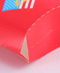 Close-up of 100 Pack Disposable Paper Snack Boxes For Chips Fries Popcorn And Candies showing red paper material corner detail.