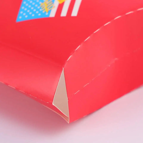 Close-up of 100 Pack Disposable Paper Snack Boxes For Chips Fries Popcorn And Candies showing red paper material corner detail.