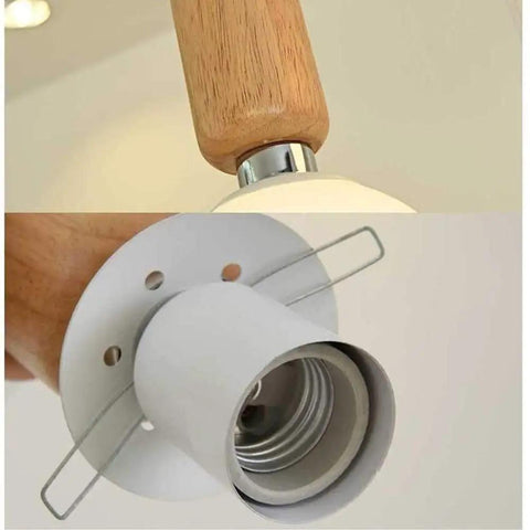 Top Shelf Three Head Disc Pendant Ceiling Light With Milky Frosted Glass Lampshades And Heavy Duty Wrought Iron Frame close-up of wooden and metal fixture.