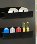 Black magnetic aerosol can holders with four hooks, holding spray cans, tape, and screwdrivers, mounted on a wall.