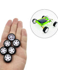 Hand holding toy wheels from Ten Piece Small Toy Car Wheel Set With 20mm Rubber Tires And 5 Shaft Axles For RC Cars Trucks Robots DIY