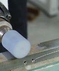 Close-up of 25Mm Cylindrical Grinding Stone Set with 1/4 Inch Shank for Rotary Tools and Drills in use on metal surface.