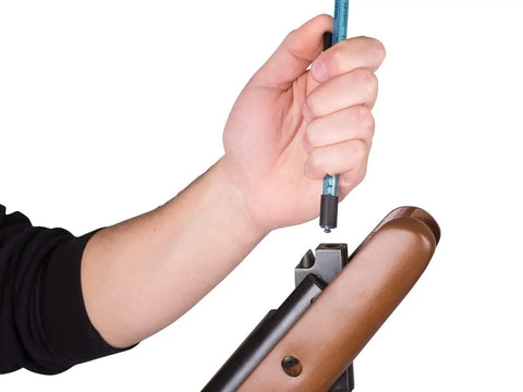 Hand using blue Dope Pellet Pen Holds 20 177 Cal Pellets Slick Reload Clip Kit for quick ammo loading into rifle