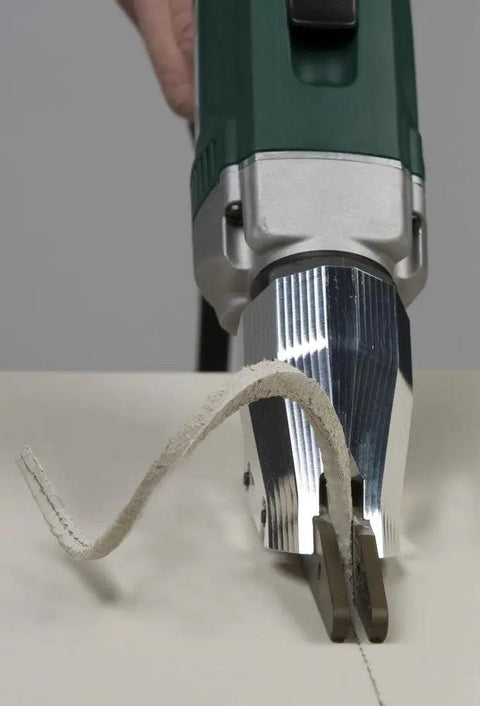 Pro Grade Heavy Duty Electric Fiber Cement Siding Cutter With Six Point Five Amp Motor cutting through fiber cement material.