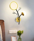 Top Shelf Modern Wall Sconce Packed With Crystal Trim And Slick Three Color Dimmable Lighting For Master Bedrooms Living Rooms And Hallways Wire Drawn Metal Body in a stylish bedroom setup.