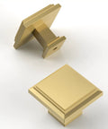 Square brushed gold cabinet knobs on white background, showcasing the sleek modern hardware design.