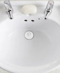 4pcs Rubber Bathtub Drain Stopper with Pull Ring in a white sink, featuring a tight sealing design for leakage prevention.