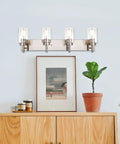 Vanity Bathroom Light Fixture In Brushed Nickel, 3 Light Modern Wall Sconce With Clear Glass Shades above a wooden cabinet