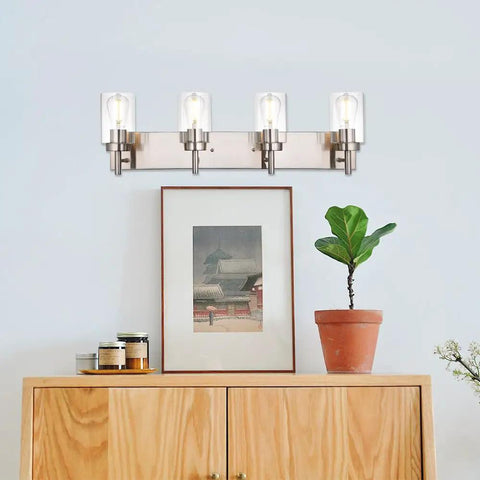 Vanity Bathroom Light Fixture In Brushed Nickel, 3 Light Modern Wall Sconce With Clear Glass Shades above a wooden cabinet