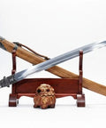 Xiuchun Dao Chinese Sabre Hand Forged Manganese Steel With Teak Wood Scabbard And Textured Alloy Fittings displayed on stand