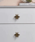 Bee Cabinet Knob Set Solid Four Pack Bumble Bee Insect Drawer Pulls Zinc Alloy Bronze Finish on white dresser