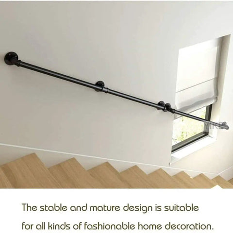 Badass Retro Industrial Water Pipe Stair Banister Lock Tight Wall Mounting No Sweat DIY Install Total Loft And Attic Safety Upgrade Sleek Wrought Iron Supports Solid Build For Life installed along a stairwell by a window.