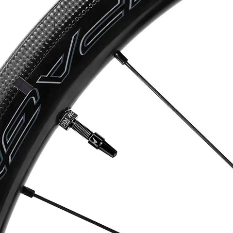 Close-up of a road bike wheel with a visible metal Presta valve for 2 Pack Ultra Light TPU Road Bike Tubes For 700x18-32C And 32-47C.