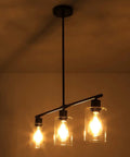Three Light Modern Kitchen Island Pendant Light With Glass Shades Slick Black Metal Finish Rustic Farmhouse Chandelier in warm light