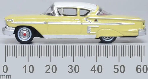 1958 Chevy Impala Sport Diecast Model Car 1/87 HO Scale Colonial Cream With Snowcrest White Top side view near ruler