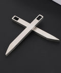 Everyday Carry Keychain Pry Bar And Bottle Opener Tool In Stainless Steel, featuring two compact multitools crossed on a black surface.