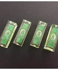4Pcs 10x10x29mm Universal Square Bubble Spirit Level Tripod Measuring Camera in clear casings on a black background.