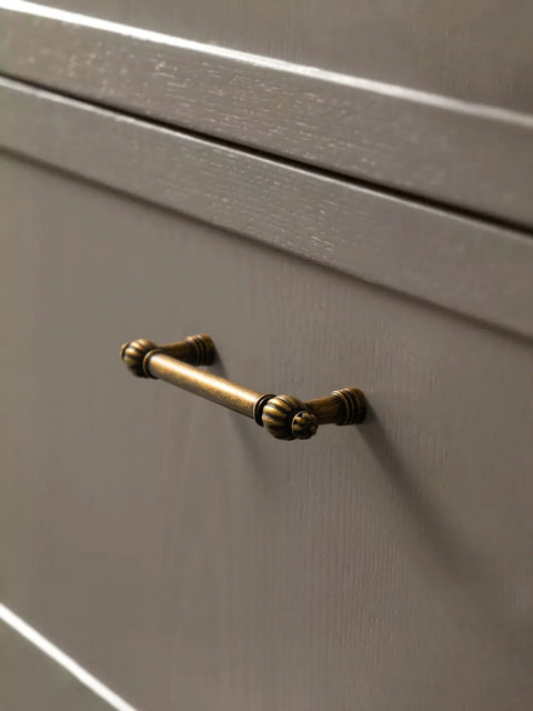Antique Brass Zinc Alloy Cabinet Pulls Three And Three Quarters Inch Hole Center installed on a kitchen cabinet drawer