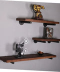 Rock Solid Heavy Duty Wall Mounted Shelf Brackets Four Pack Black Iron Pipe Style holding rustic wooden shelves with decor items.