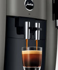 Premium Smart Automatic Coffee And Espresso Machine Featuring One Touch Brewing Sweet Foam Syrup Function that pours espresso into a glass.