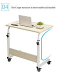 Grab And Go Adjustable Laptop Desk With Smooth Casters Dead Simple Height Tweaks For Living Room Hustle Setup Or Bedside Chill Spot In Modern Matte Black Finish, C-type structure with laptop and plant.