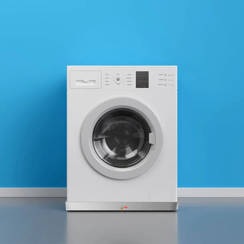Front view of a washing machine on a Heavy Duty Stainless Steel Washing Machine Pan 27x25x2.5 Inches, 18 Gauge Drain Tray With Drain Hole And Hose Adapter, 304 Stainless Steel Under-Washer Drip Pan For Leaks And Mess Prevention.