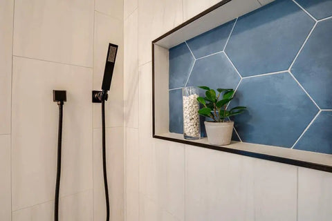 Matte Black Square Wall Elbow For Handheld Shower Durable Solid Brass Fitting With One Half Inch IPS Female Inlet And One Half Inch NPSM Outlet Leak Proof Modern Square Design That Fits Standard Hoses And Hand Showers installed in bathroom with blue tile accent.