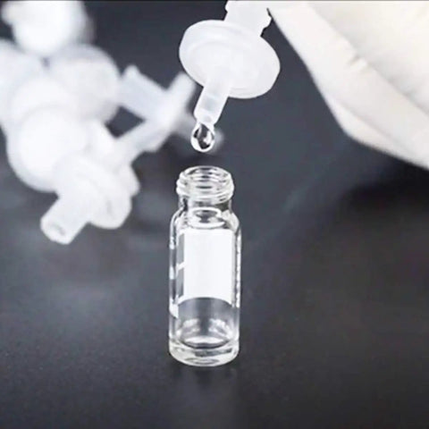 Hydrophobic PTFE Syringe Filters 13mm Diameter 0.22 Micron Pore for Industrial Filtration, with vial and dropping liquid, lab scene