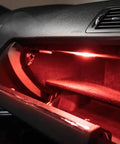 Kickin Red LED Glove Box And Footwell Lights For Volkswagen Vehicles installed in glove box, emitting red glow, interior view