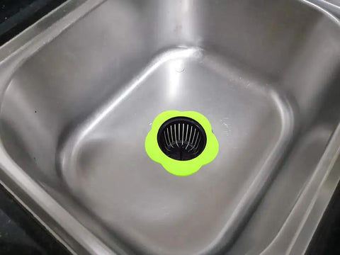 Go-To Kitchen Sink Strainer 4 Pack Silicone Drain Filters With Wide Rim 4.5 Inch Diameter in green, shown in a stainless steel sink