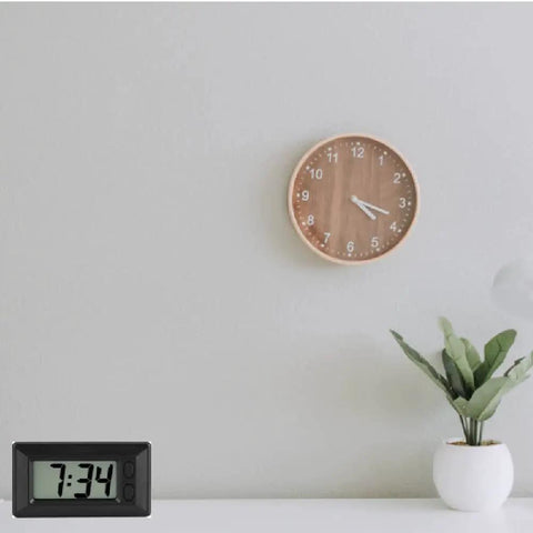 Ultra Thin Digital Clock With Wide Lcd Panel And Adhesive Mount For Car Dashboard Home Desk Ride Ready displaying time 7:34 on a table.