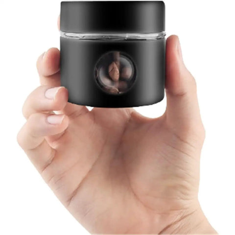 Solid Vacuum Sealed Coffee Canister With Date Dial Crafted From Heavy Duty 304 Stainless Steel Moisture Proof Jar held in hand with coffee beans inside.