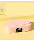 Knockout Portable Ultrasonic Cleaner For Glasses And Jewelry Using High Frequency Vibration And Eco Friendly Deep Wash Tech To Make Your Treasures Look Slick And Sparkling Fresh In Pink, with reading glasses beside it.