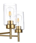 Close-up of clear glass shades with bulbs on a modern matte black pendant lighting for dining room and kitchen island chandelier.