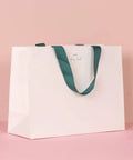 Custom White Paper Bags 100 Pack With Logo Printing 21.7x6.1x15.7 Inches 250G Thick Paper with green 1-inch color handles