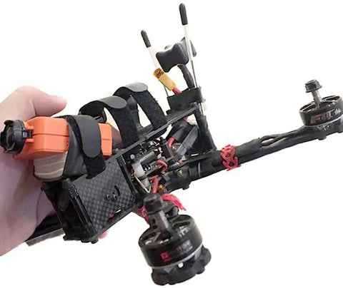 Hand holding a quadcopter drone with visible wiring and mounted RC antenna tube kit for RC boat, aluminum mount and black plastic tube.