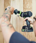 Person using Heavy Duty Brushless Cordless Drill And Driver With Unbreakable Gears And 18 Volt Battery on wooden wall.