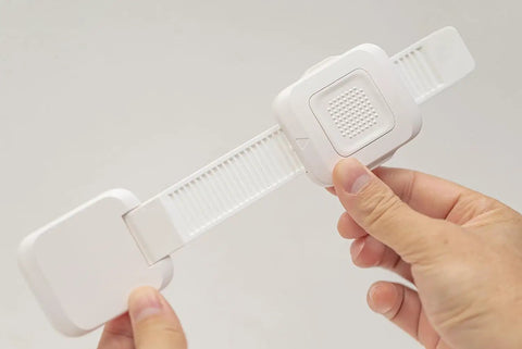 Heavy Duty No Drill Furniture Anchors For Baby Proofing with upgraded adhesive straps in hand for easy installation.