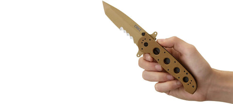 Hand holding M16-14DSFG Folding Knife With Liner Lock And Veff Serrations, showing G10 handle and serrated blade.